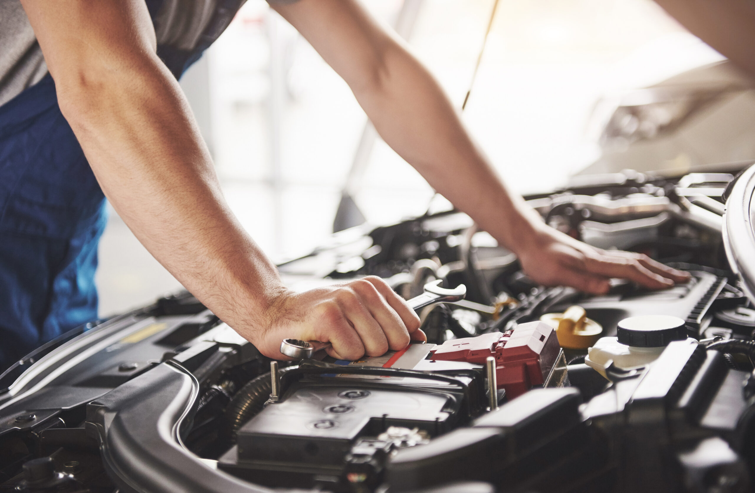 Auto mechanic working in garage. Repair service